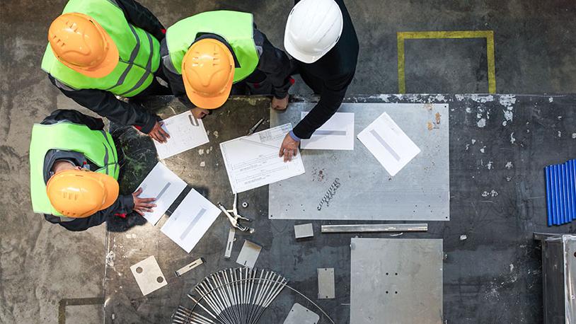 construction workers looking over blueprints